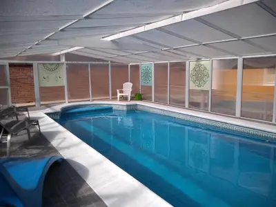 a large swimming pool in a building at Cabañas Pio Pio in Merlo