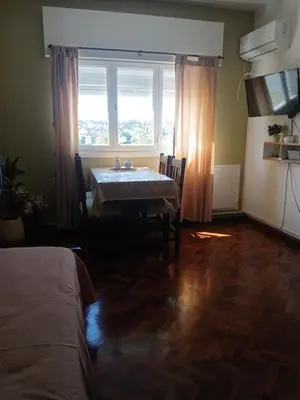 a dining room with a table and a window at Departamento Monoambiente Centro Villa Carlos Paz in Villa Carlos Paz