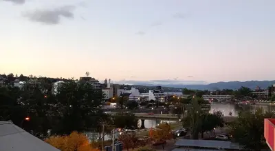 a view of a city with a river and buildings at Departamento Monoambiente Centro Villa Carlos Paz in Villa Carlos Paz