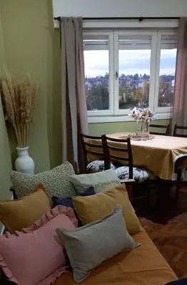 a room with a table with pillows and a window at Departamento Monoambiente Centro Villa Carlos Paz in Villa Carlos Paz