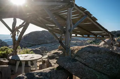 a wooden pergola with a table on a mountain at Rustic Mountain Shelter Pure Nature in Las Rabonas