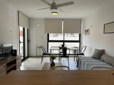 a living room with a couch and a table at Depto Paseo Quattro in Villa Carlos Paz