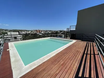 a swimming pool on the roof of a building at Depto Paseo Quattro in Villa Carlos Paz