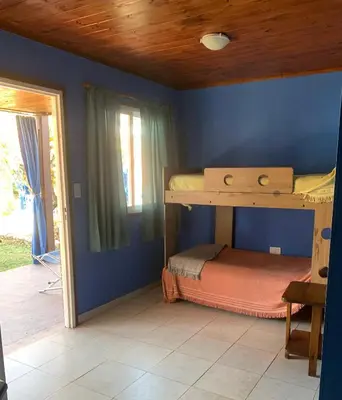a bedroom with bunk beds in a blue wall at Don Valerio in Mina Clavero
