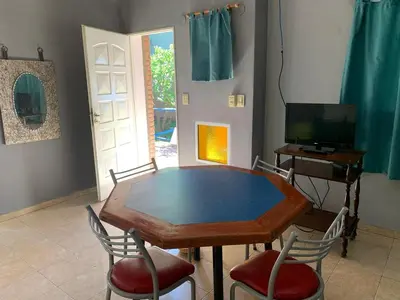 a dining room with a table and chairs and a television at Don Valerio in Mina Clavero