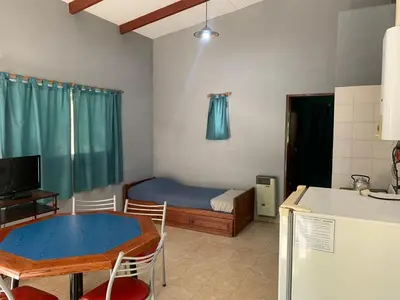 a room with a table and a bed and a kitchen at Don Valerio in Mina Clavero