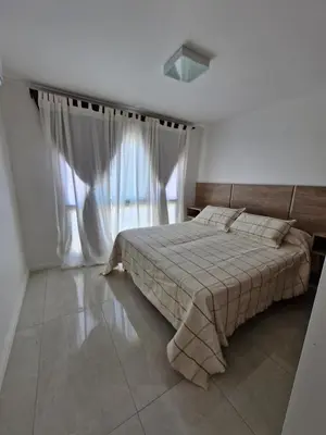 a bedroom with a bed and a large window at Bonito departamento in Cordoba