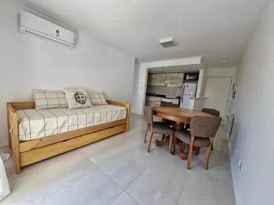 a bedroom with a bed and a table and chairs at Bonito departamento in Cordoba