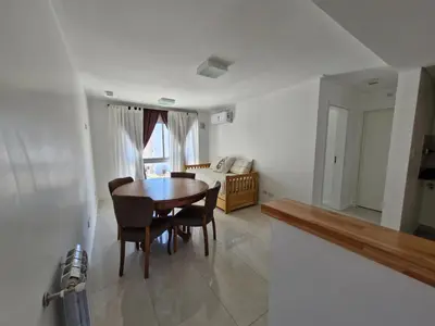 a dining room with a table and chairs and a couch at Bonito departamento in Cordoba