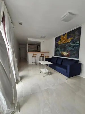 a living room with a blue couch and a table at Agradable departamento in Cordoba