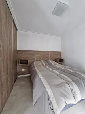 a bedroom with a large bed in a white room at Agradable departamento in Cordoba
