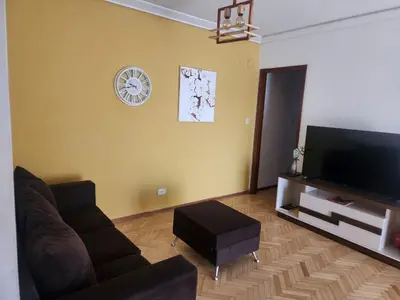 a living room with a couch and a flat screen tv at FANTASTICO departamento en el CENTRO DE CARLOS PAZ in Villa Carlos Paz