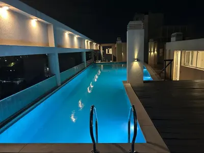 a swimming pool at night in a hotel at Depto Balcones Cofico 4 in Cordoba