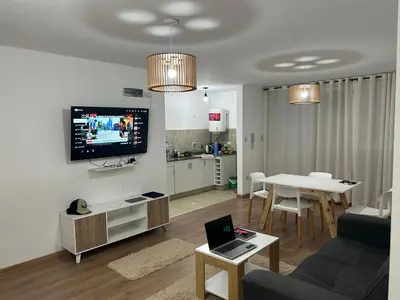 a living room with a couch and a table with a tv at Depto Balcones Cofico 4 in Cordoba
