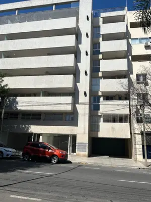 a red car parked in front of a building at Depto Balcones Cofico 4 in Cordoba