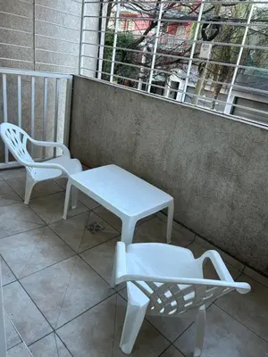 a bench and a table and a chair on a balcony at Depto Balcones Cofico 4 in Cordoba