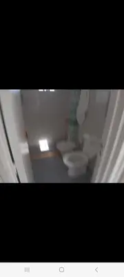 a white bathroom with two toilets in a room at Derpa zion in Cordoba