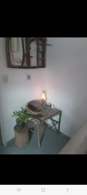a table with a lamp on it in a room at Derpa zion in Cordoba