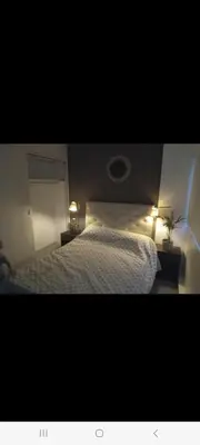a bedroom with a bed with two lights on it at Derpa zion in Cordoba