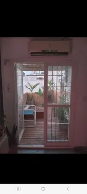 a door to a balcony with a view of a patio at Derpa zion in Cordoba