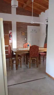 a dining room with a wooden table and chairs at Tierra Mia in Carpintería