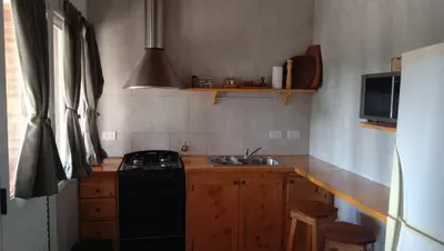 a kitchen with a black stove and a sink at Tierra Mia in Carpintería