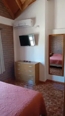 a bedroom with a bed and a tv and a mirror at Tierra Mia in Carpintería