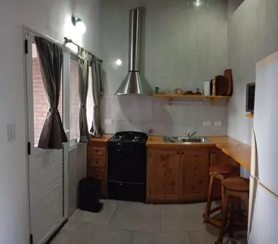 a kitchen with a black stove and a sink at Tierra Mia in Carpintería