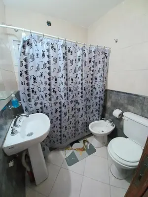 a bathroom with a sink and a toilet and a shower curtain at Tierra Mia II in Carpintería