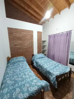 a room with two beds and a purple curtain at Tierra Mia II in Carpintería