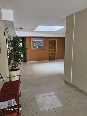 a large room with a potted plant in a building at Dpto Centrico Carlos Paz in Villa Carlos Paz