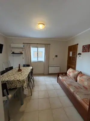 a living room with a table and a couch at Dpto Centrico Carlos Paz in Villa Carlos Paz