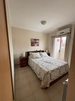 a bedroom with a large bed and a window at Dpto Centrico Carlos Paz in Villa Carlos Paz