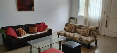 a living room with a couch and a chair at DEPARTAMENTO CORDOBA Capital ZONA NORTE in Cordoba