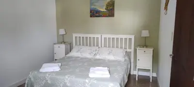 a small bedroom with a bed with two night stands at DEPARTAMENTO CORDOBA Capital ZONA NORTE in Cordoba