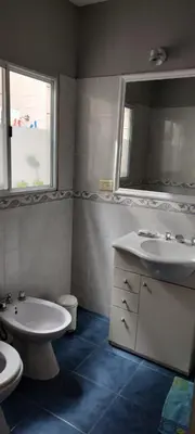a bathroom with a sink and a toilet and a mirror at DEPARTAMENTO CORDOBA Capital ZONA NORTE in Cordoba