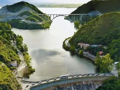 a bridge over a river with cars driving on it at MIRADOR Rest House in Bialet Massé