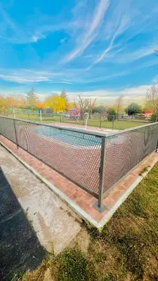 a fence in a park with a tennis court at MIRADOR Rest House in Bialet Massé