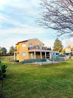 a large house with a lawn in front of it at MIRADOR Rest House in Bialet Massé