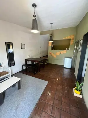 a living room with a table and a couch at Moderno PH, céntrico y económico, muy comodo, cocina, wifi, cochera techada privada in Cordoba