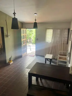 a living room with a table and a couch at Moderno PH, céntrico y económico, muy comodo, cocina, wifi, cochera techada privada in Cordoba