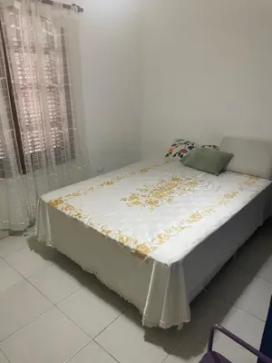 a bedroom with a bed with a white blanket at Casa Alvarez in Villa Carlos Paz
