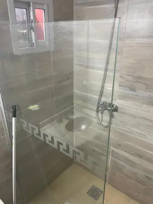 a shower with a glass door in a bathroom at Casa Alvarez in Villa Carlos Paz