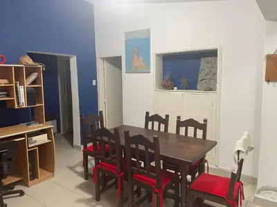 a dining room with a wooden table and chairs at Casa Alvarez in Villa Carlos Paz