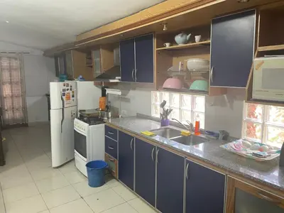 a kitchen with blue cabinets and a white refrigerator at Casa Alvarez in Villa Carlos Paz