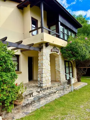a house with a balcony on top of it at Posada del Valle solo adultos in Merlo