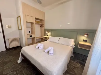 a bedroom with a bed with two towels on it at Posada del Valle solo adultos in Merlo