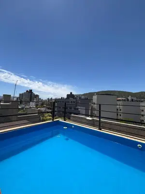 a swimming pool on the roof of a building at Sunset SORRENTO con Cochera in Villa Carlos Paz