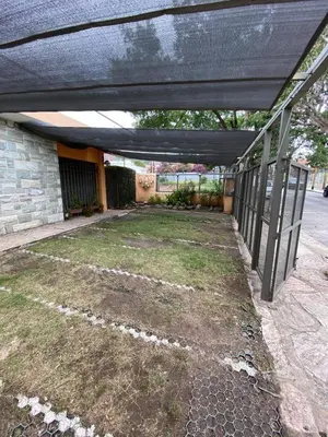 an empty backyard with a black overhang on a house at Tica Masu in Villa Carlos Paz