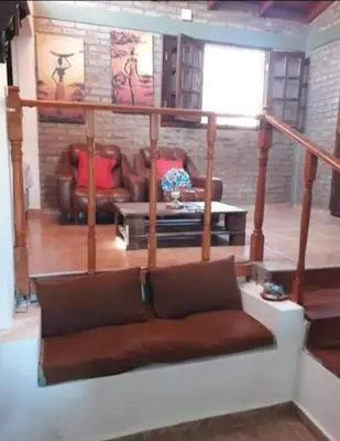 a living room with a couch and a table at Lomas De Piquillin in Villa Carlos Paz